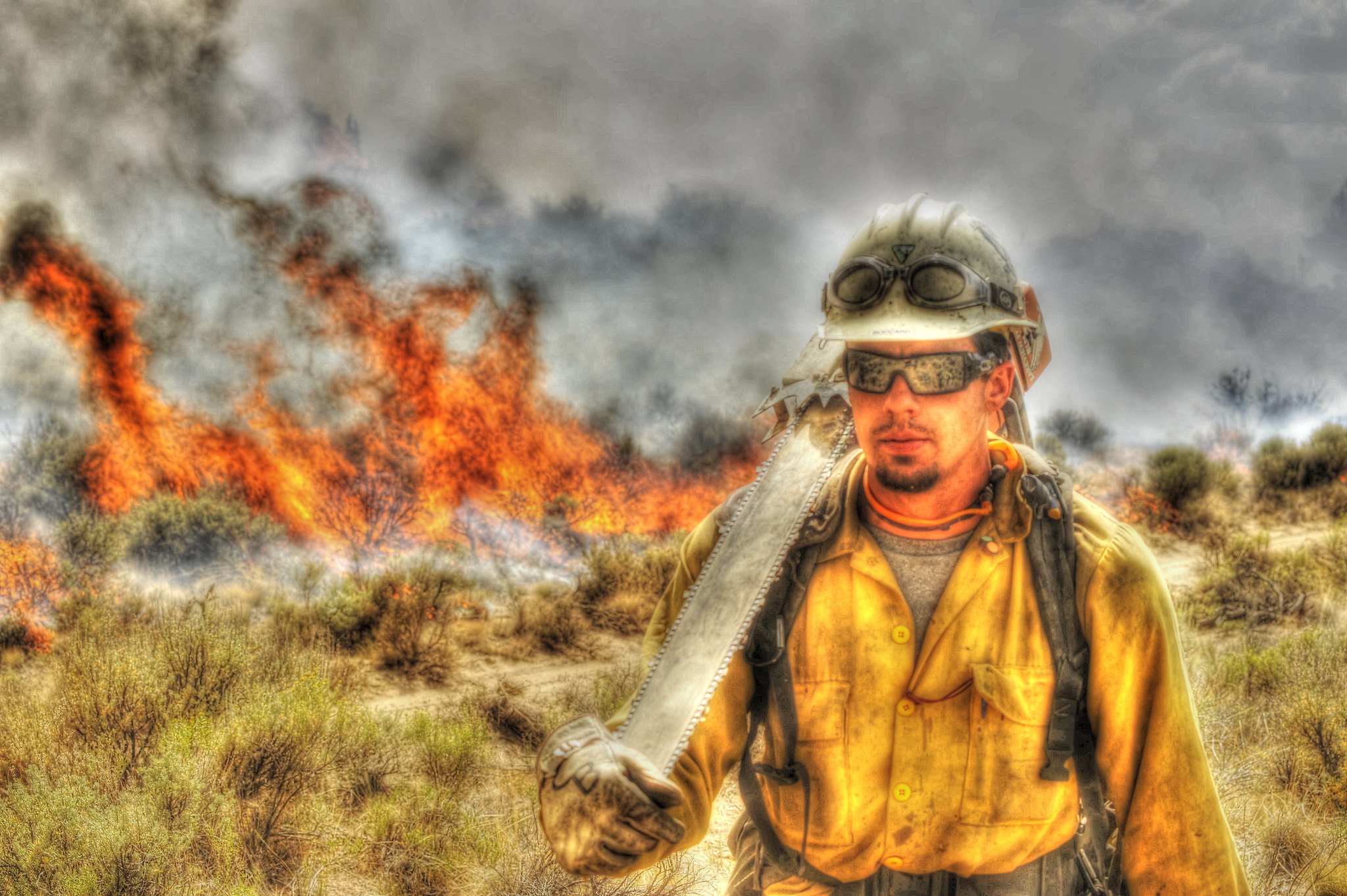Wildland Firefighter with flames behind him